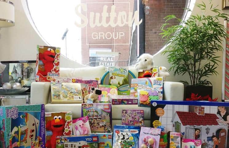 Sutton Group Realty Systems fills its window with gifts for children