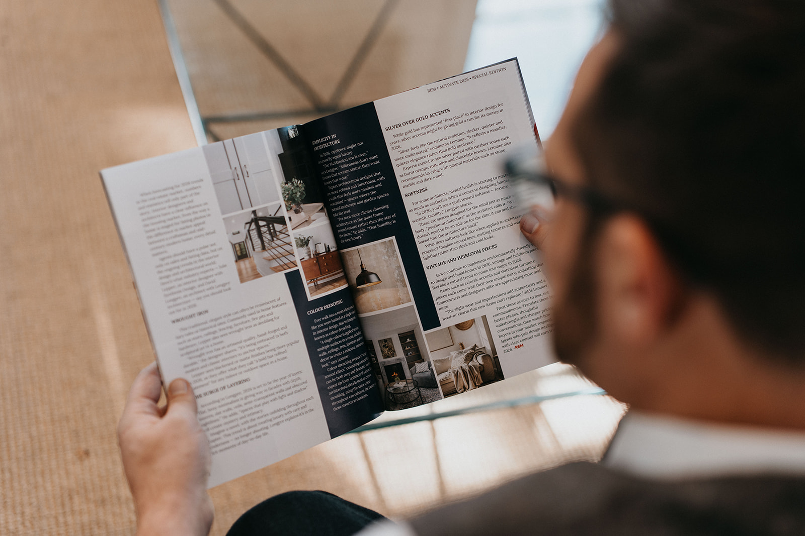A reader holding open a previous REM print edition